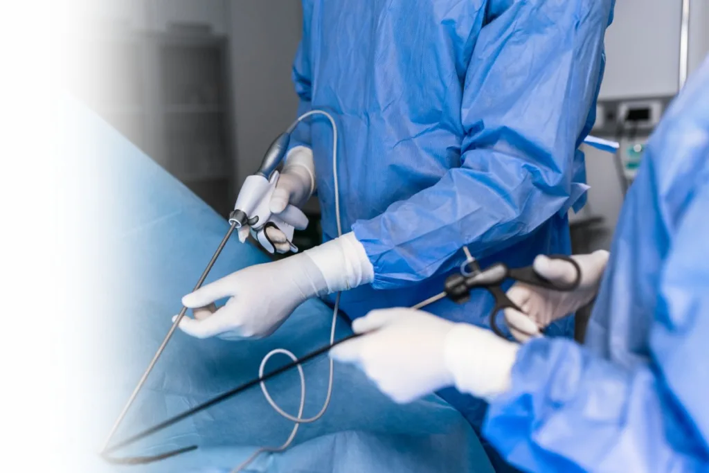 The surgeon's holing the instrument in abdomen of patient. The surgeon's doing laparoscopic surgery in the operating room. Minimally invasive surgery.